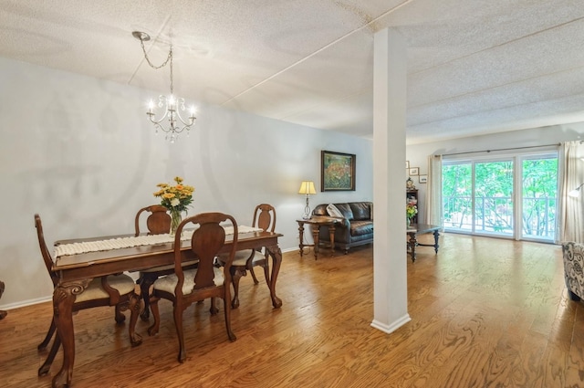 460 S NW Hwy Unit 309A, Park Ridge, IL 60068 - dining room with a textured ceiling, wood finished floors, baseboards, and a chandelier