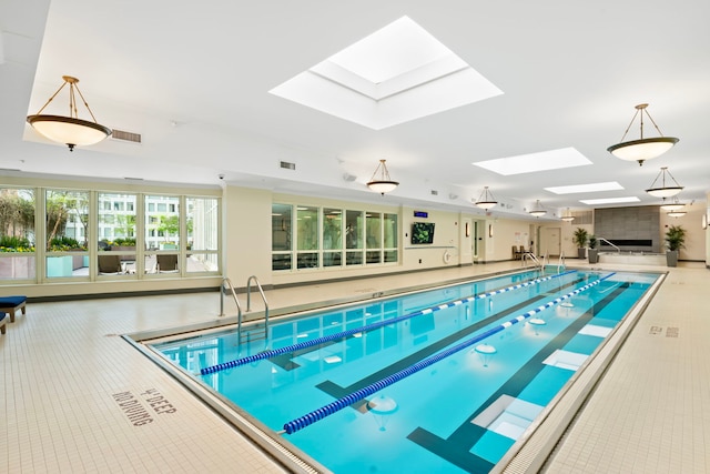 indoor community pool with a skylight