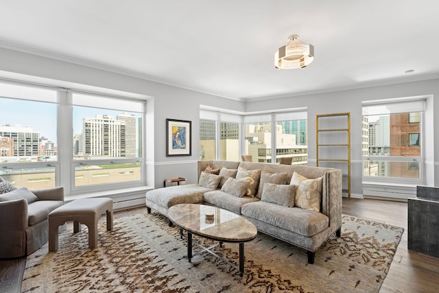 living room with ornamental molding and wood finished floors
