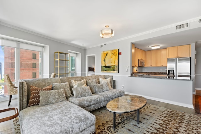 living area featuring dark wood finished floors, ornamental molding, and baseboards