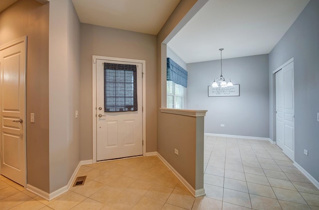 612 Freedom Way, Shorewood, IL 60404 - foyer entrance featuring light tile patterned floors, a chandelier, and baseboards
