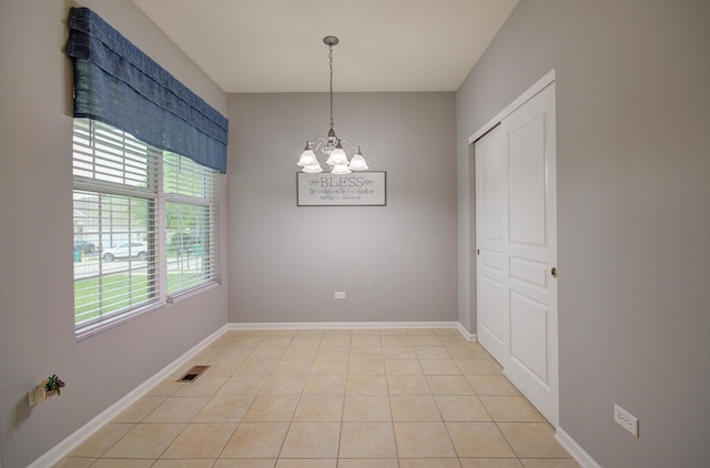 612 Freedom Way, Shorewood, IL 60404 - unfurnished dining area with a chandelier, light tile patterned floors, and baseboards