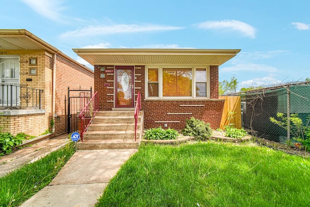 12617 S Michigan Ave, Chicago, IL 60628 - view of front facade featuring fence and brick siding