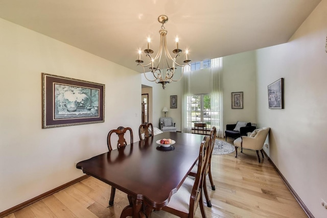 5506 Hickory Grove Ct, Plainfield, IL 60586 - dining space featuring light wood finished floors, a chandelier, and baseboards
