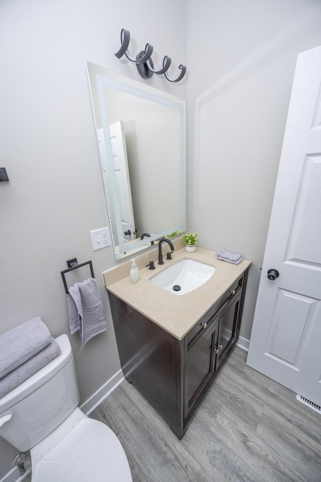 23049 W Andrew Ave, Channahon, IL 60410 - bathroom featuring wood finished floors, toilet, vanity, and baseboards