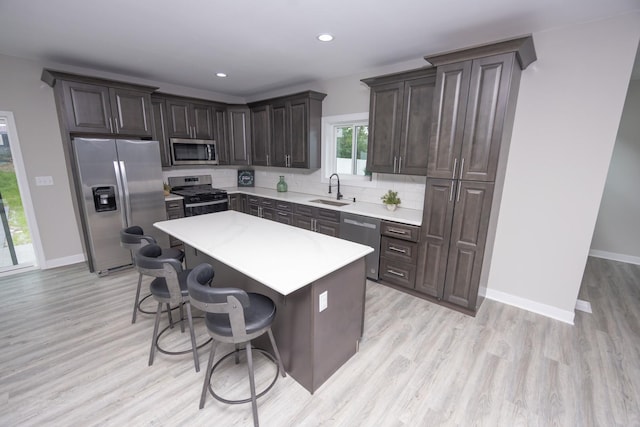 23049 W Andrew Ave, Channahon, IL 60410 - kitchen featuring stainless steel appliances, a sink, a kitchen breakfast bar, light countertops, and a kitchen island