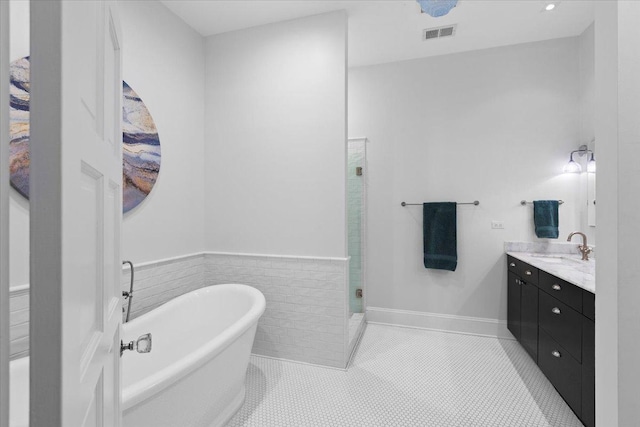 1313 N Wood St Unit 2, Chicago, IL 60622 - full bath featuring vanity, a freestanding tub, a stall shower, and tile patterned flooring