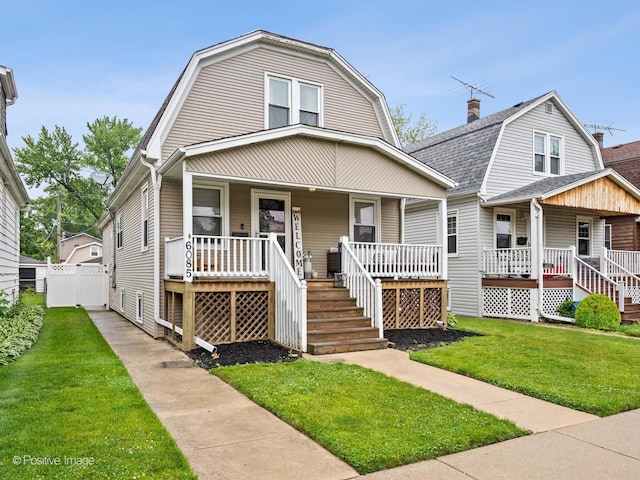 6085 N Nassau Ave, Chicago, IL 60631 - colonial inspired home with a porch, a gambrel roof, and a front lawn