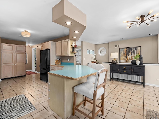 6085 N Nassau Ave, Chicago, IL 60631 - kitchen with freestanding refrigerator, light brown cabinetry, light tile patterned flooring, a kitchen bar, and baseboards
