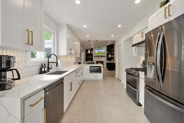 kitchen featuring stainless steel appliances, a sink, under cabinet range hood, decorative backsplash, and recessed lighting