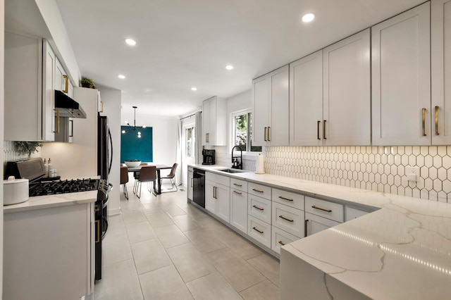kitchen with gas range, a sink, black dishwasher, recessed lighting, and decorative backsplash