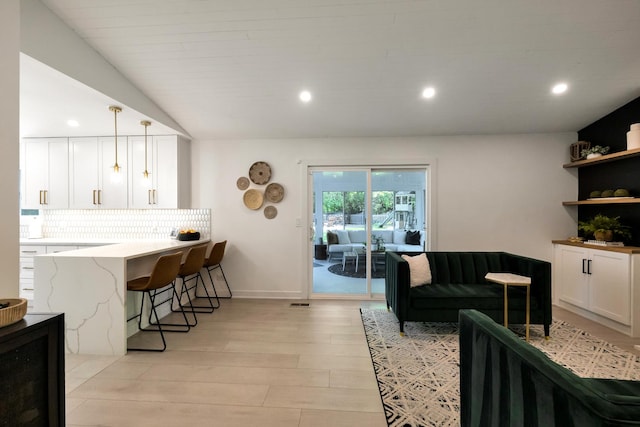 living area featuring light wood finished floors, recessed lighting, and baseboards