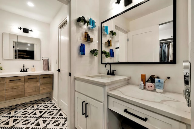 full bathroom with two vanities, tile patterned flooring, and recessed lighting