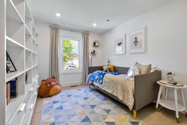 bedroom with baseboards, recessed lighting, and light wood finished floors