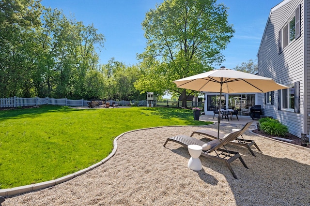 view of yard featuring a playground and a patio area