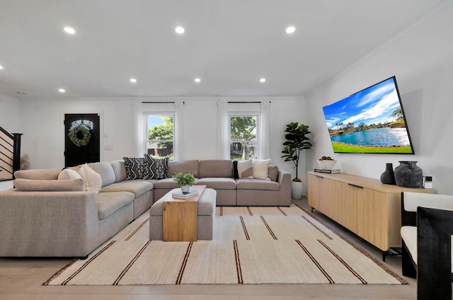 living room with recessed lighting, crown molding, and stairs