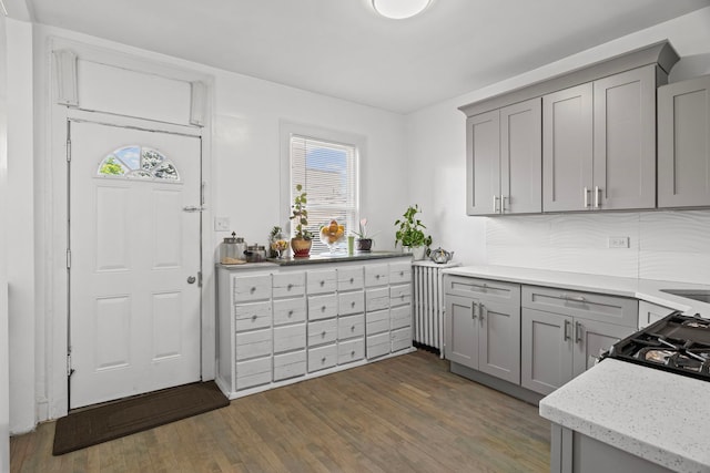 2018 N Laporte Ave, Chicago, IL 60639 - kitchen featuring gray cabinets, plenty of natural light, dark wood-style floors, and light stone counters