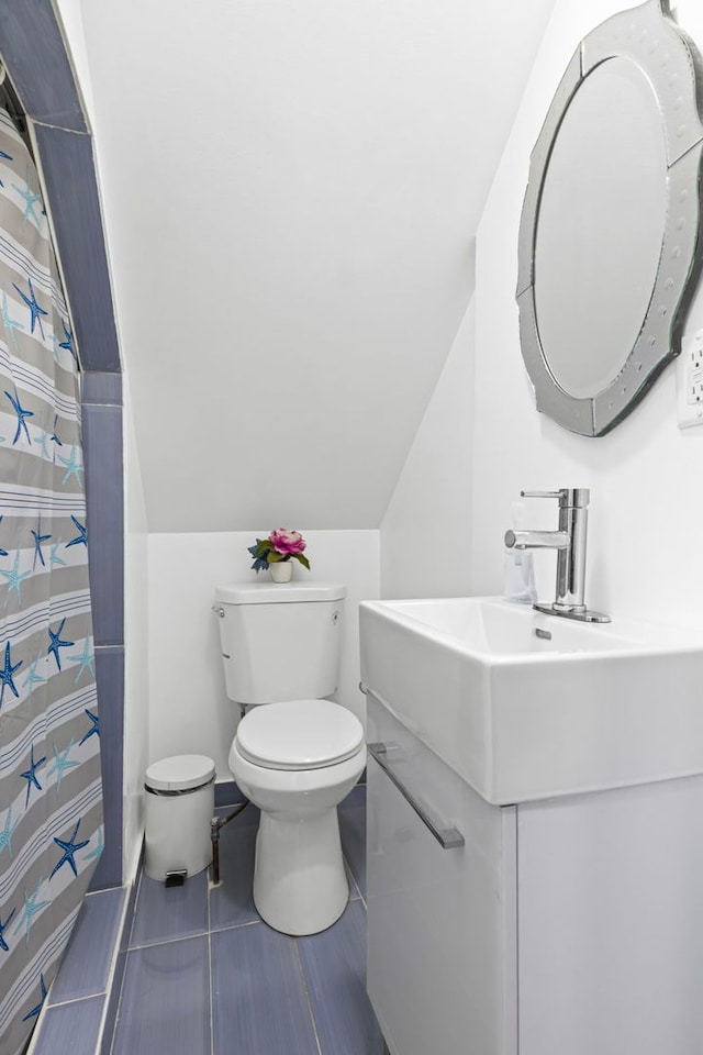 2018 N Laporte Ave, Chicago, IL 60639 - bathroom featuring toilet, vanity, vaulted ceiling, tile patterned flooring, and curtained shower