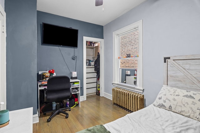 2018 N Laporte Ave, Chicago, IL 60639 - bedroom with radiator heating unit, wood finished floors, an office area, baseboards, and ceiling fan