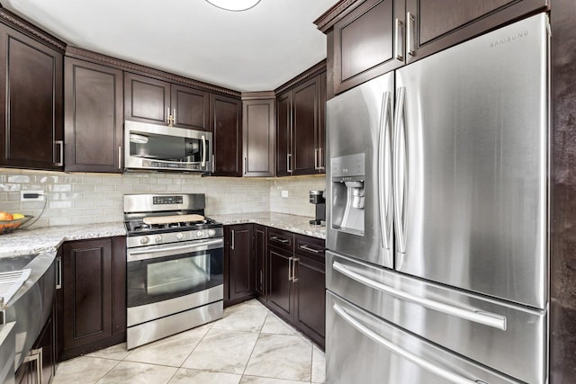 576 Aspen Dr, Lombard, IL 60148 - kitchen featuring stainless steel appliances, light stone countertops, dark brown cabinets, and decorative backsplash