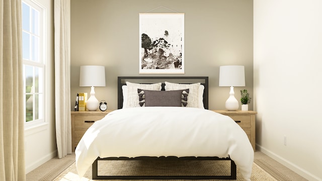 bedroom featuring multiple windows, baseboards, and light carpet