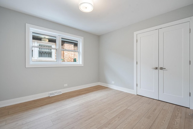 7306 W Pensacola Ave, Norridge, IL 60706 - unfurnished bedroom featuring light wood finished floors, baseboards, and a closet