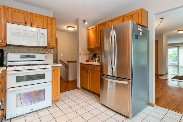 20827 W Torrey Pines Ln, Plainfield, IL 60544 - kitchen with white appliances, light countertops, decorative backsplash, and light tile patterned floors