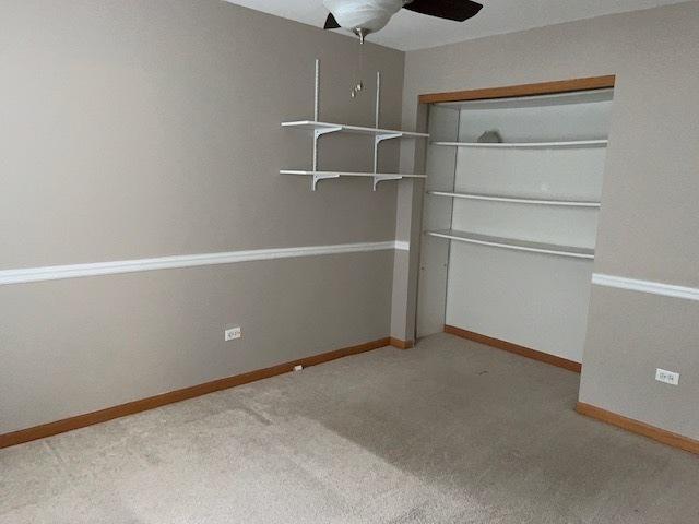 20827 W Torrey Pines Ln, Plainfield, IL 60544 - unfurnished bedroom with carpet floors, a closet, ceiling fan, and baseboards