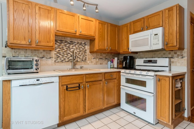 20827 W Torrey Pines Ln, Plainfield, IL 60544 - kitchen featuring white appliances, a sink, light countertops, and decorative backsplash