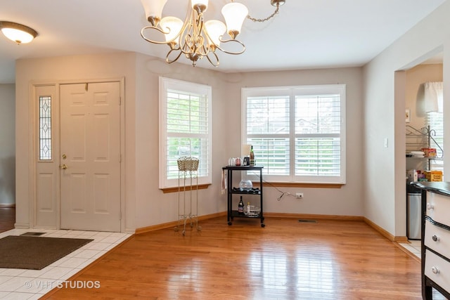 20827 W Torrey Pines Ln, Plainfield, IL 60544 - foyer with light wood-style flooring, a chandelier, and baseboards