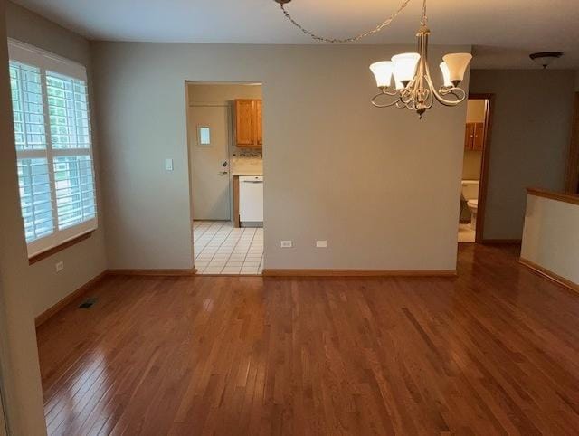 20827 W Torrey Pines Ln, Plainfield, IL 60544 - empty room with light wood-style floors, plenty of natural light, and a chandelier