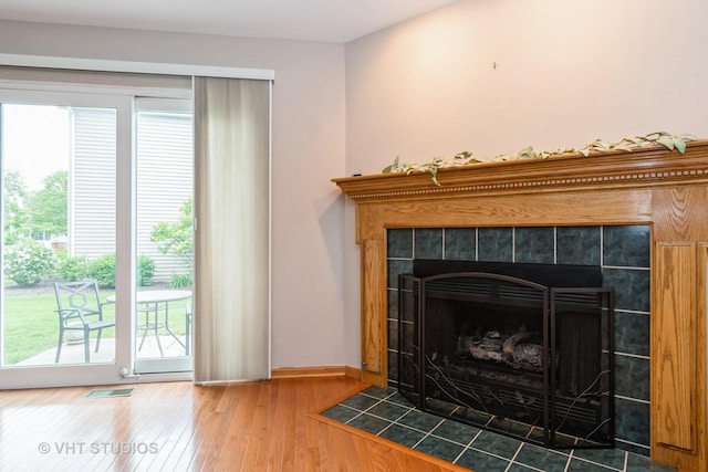 20827 W Torrey Pines Ln, Plainfield, IL 60544 - detailed view of a tiled fireplace, wood finished floors, and baseboards