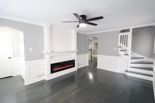 10817 S Eberhart Ave, Chicago, IL 60628 - unfurnished living room with arched walkways, a ceiling fan, dark wood-style floors, a fireplace, and a wainscoted wall