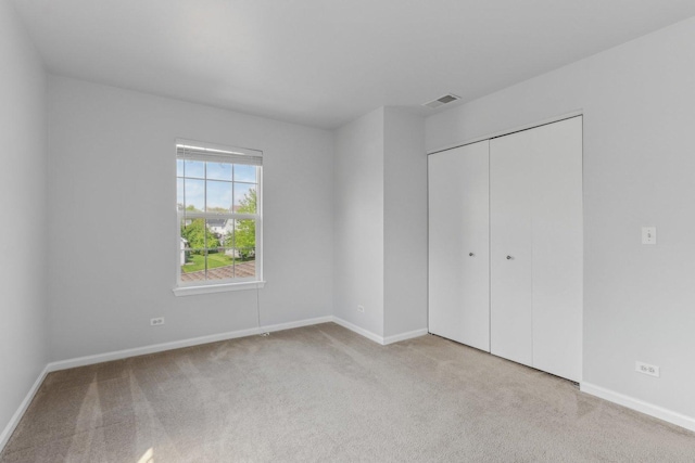 2007 S Kristina Ln, Round Lake, IL 60073 - unfurnished bedroom with carpet floors, baseboards, and a closet