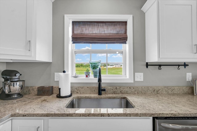 7 Connor Ct, Monticello, IL 61856 - kitchen featuring a sink, dishwasher, and white cabinets
