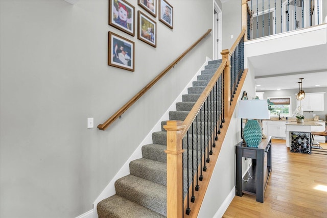 7 Connor Ct, Monticello, IL 61856 - stairs with wood finished floors, baseboards, and a towering ceiling