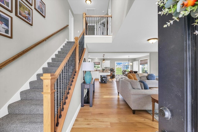 7 Connor Ct, Monticello, IL 61856 - stairs with wood finished floors, a high ceiling, and a chandelier