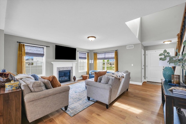 7 Connor Ct, Monticello, IL 61856 - living room featuring light wood finished floors, a high end fireplace, and baseboards