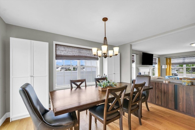 7 Connor Ct, Monticello, IL 61856 - dining area with light wood-type flooring, a chandelier, and baseboards
