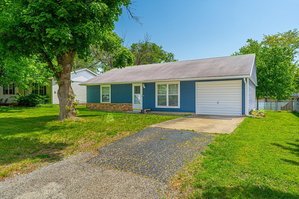 1034 N Monroe St, Lincoln, IL 62656 - single story home featuring asphalt driveway, a garage, and roof with shingles