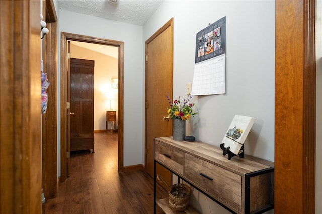 1401 Bethany Ln, Pontiac, IL 61764 - hall with dark wood-style floors, a textured ceiling, and baseboards
