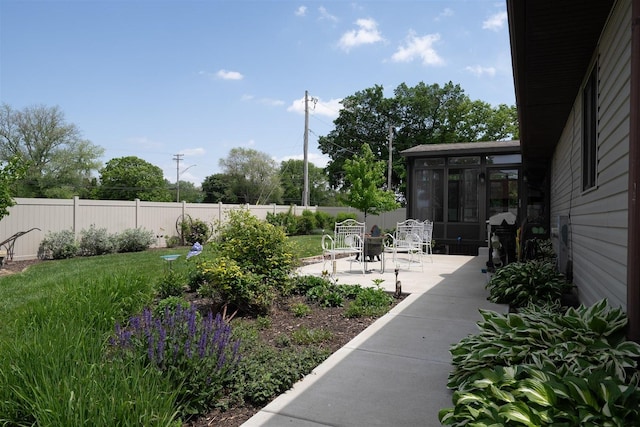 1401 Bethany Ln, Pontiac, IL 61764 - view of yard featuring a sunroom, fence, and a patio area