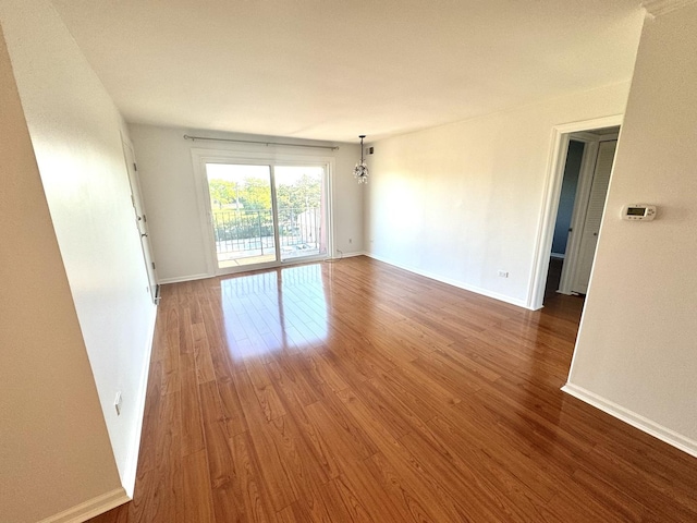unfurnished room featuring wood finished floors and baseboards