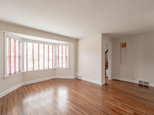 7300 S Talman Ave, Chicago, IL 60629 - empty room with plenty of natural light, wood finished floors, and baseboards