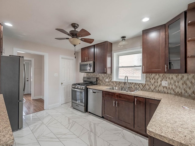 7300 S Talman Ave, Chicago, IL 60629 - kitchen with stainless steel appliances, a sink, light countertops, dark brown cabinetry, and recessed lighting