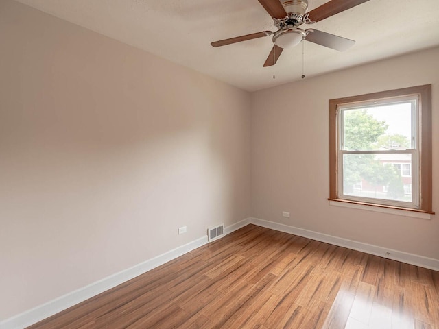 7300 S Talman Ave, Chicago, IL 60629 - unfurnished room featuring light wood-type flooring, baseboards, and a ceiling fan