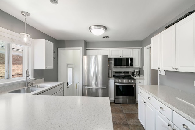 3156 W 100th St, Evergreen Park, IL 60805 - kitchen with stainless steel appliances, a sink, white cabinetry, decorative light fixtures, and dark tile patterned floors