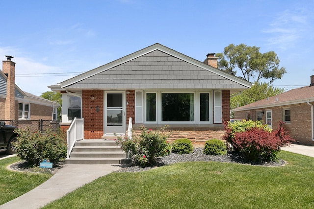 3156 W 100th St, Evergreen Park, IL 60805 - view of front of house with a front lawn, a chimney, covered porch, and brick siding