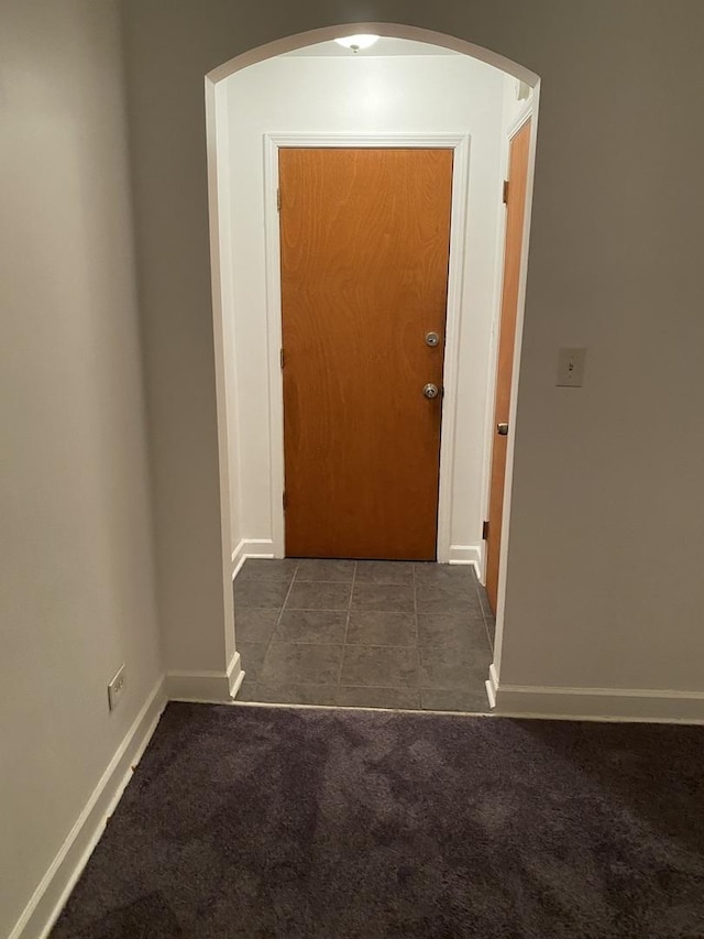 808 Bellwood Ave Unit 1N, Bellwood, IL 60104 - corridor with arched walkways, baseboards, carpet floors, and tile patterned floors