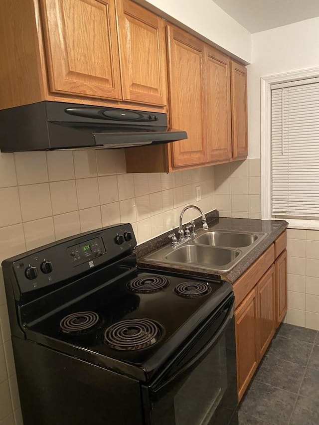 808 Bellwood Ave Unit 1N, Bellwood, IL 60104 - kitchen with electric range, under cabinet range hood, a sink, dark countertops, and brown cabinetry